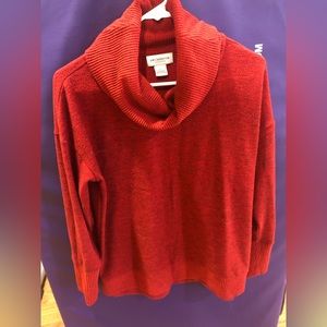 Red sweater with cowl neck.